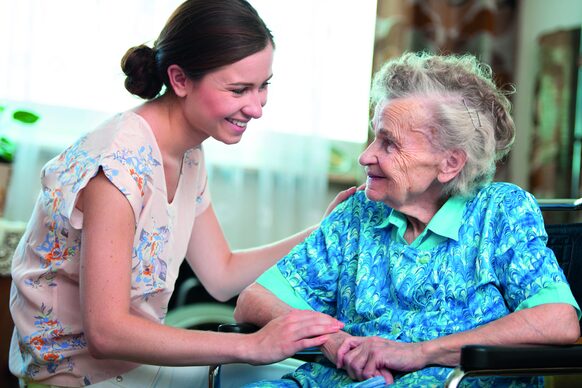 Senior woman with her caregiver at home